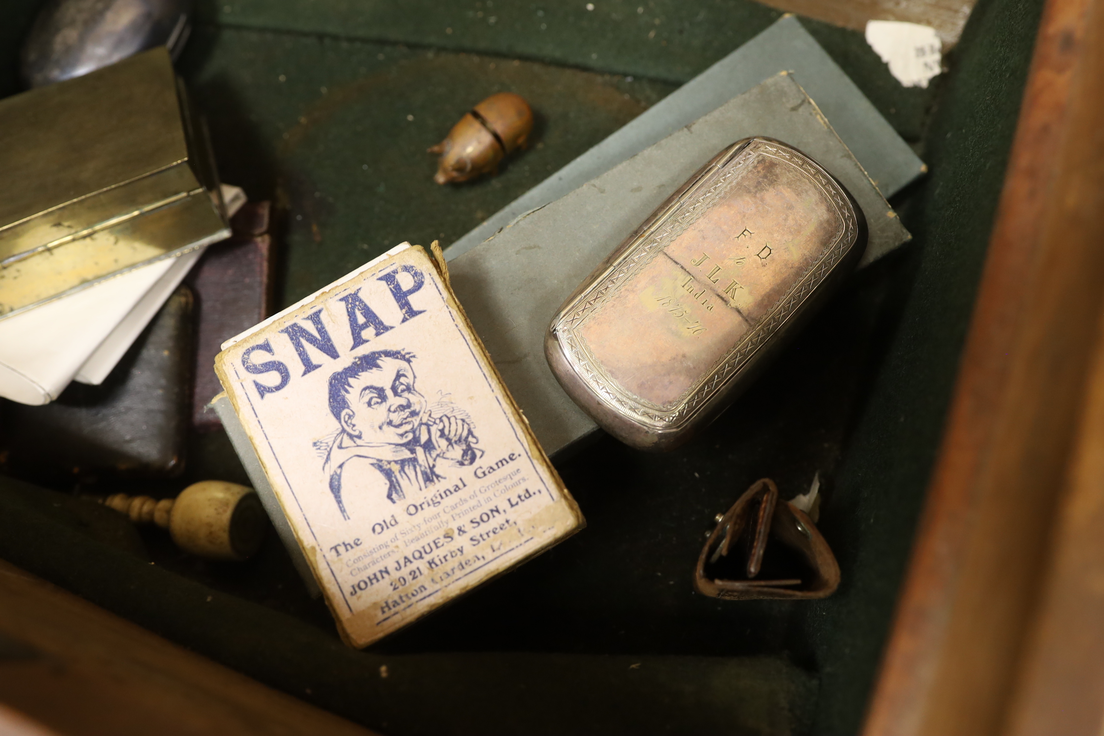 A mahogany strong box containing a small quantity of miscellaneous items, including snuff boxes